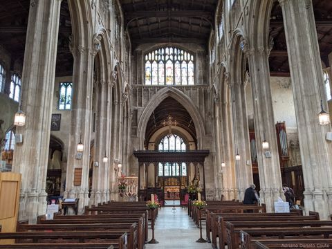 Interior de uma igreja, com o alter ao fundo. O templo é ladeado por enormes colunas de pedra.